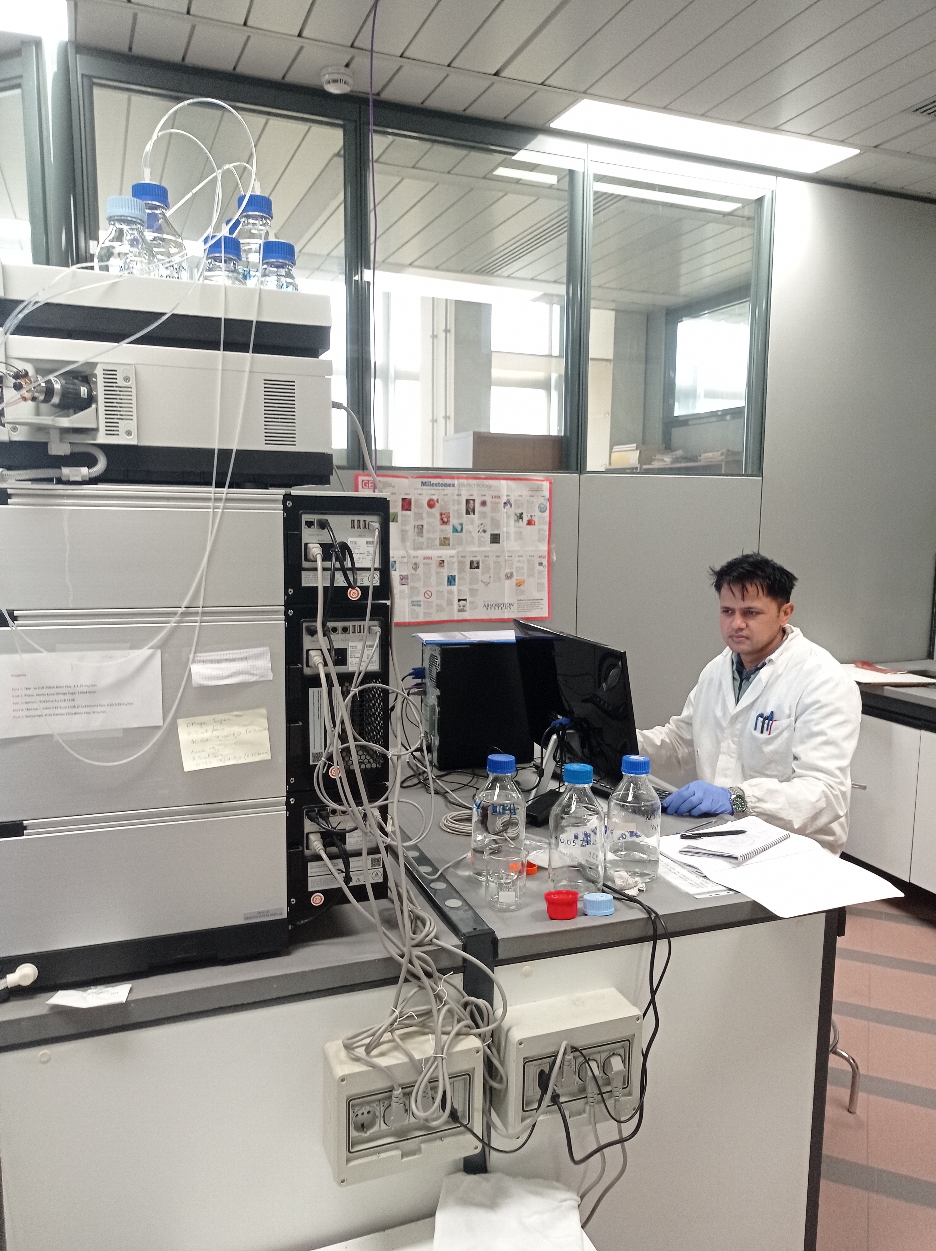 Dipak Paudel operating high-resolution LC-MS instrument workstation at University of Trieste